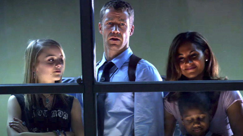 Zoe Carter, Jack Carter, and Allison Blake looking through a window