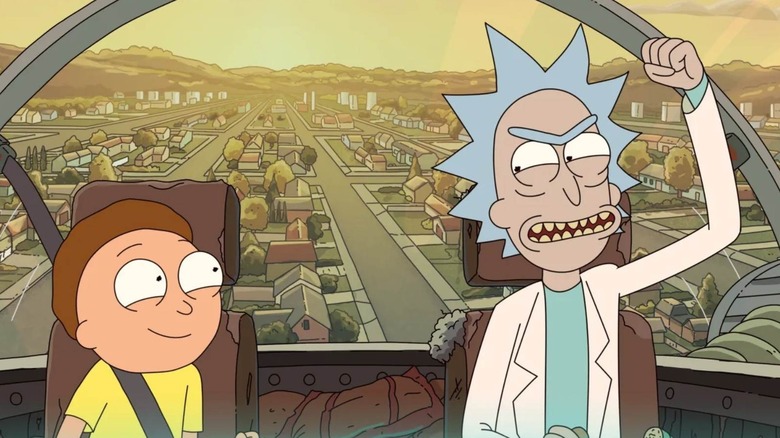 Morty Smith smiling at Rick Sanchez as they fly in a spaceship