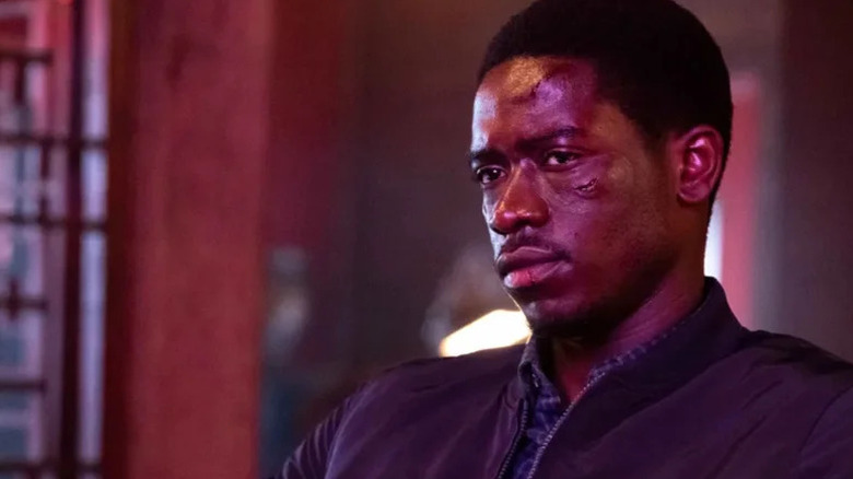 A bruised Franklin Saint (Damson Idris) sits in a neon-lit room in Snowfall