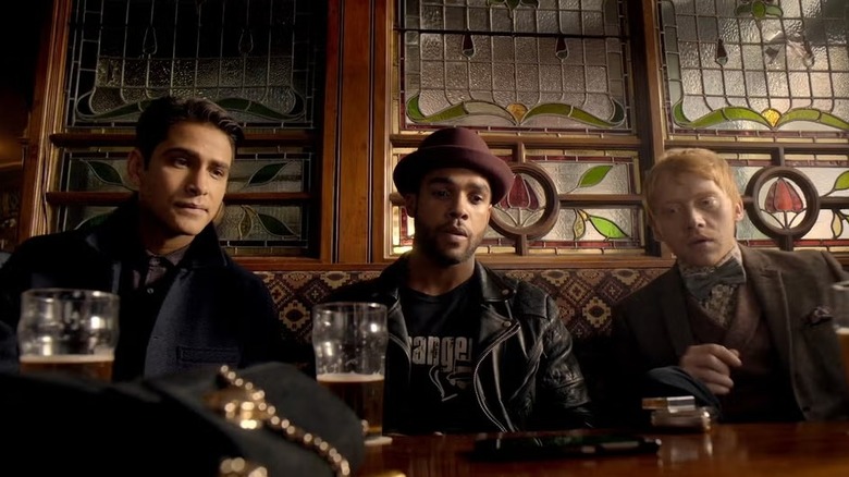 Albert Hill (Luke Pasqualino), Billy Ayres (Lucien Laviscount), and Charlie Cavendish-Scott (Rupert Grint) sit with their beers in Snatch