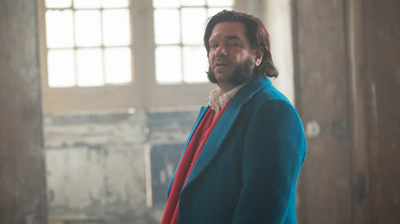 Eli Rabbit (Matt Berry) stands in a dingy room in Year of the Rabbit