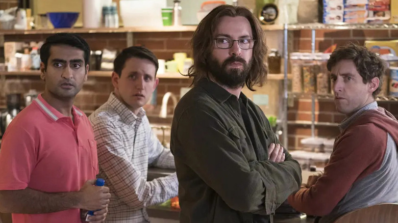 Dinesh Chugtai (Kumail Nanjiani), Jared Dunn (Zach Woods), Bertram Gilfoyle (Martin Starr), and Richard Hendricks (Thomas Middleditch) look apprehensive in a storeroom in Silicon Valley