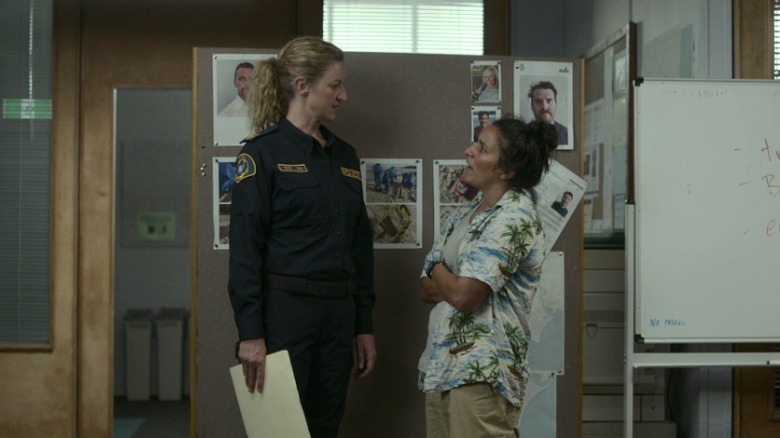 Dulcie (Kate Box) and Eddie (Madeleine Sami) staring each other down on Deadloch S1E1