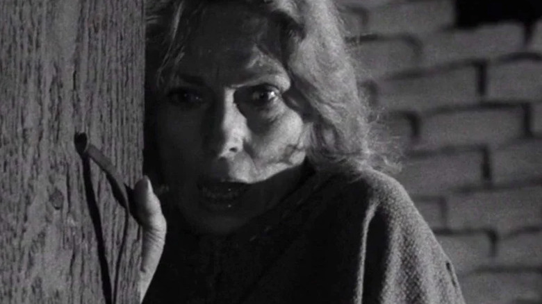 The woman (Agnes Moorehead) reacts in shock while opening a door in The Twilight Zone (1959)