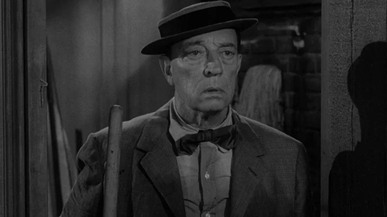 Woodrow Mulligan (Buster Keaton) stands morosely holding a mop in The Twilight Zone (1959)