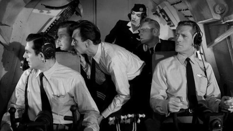 A flight crew looks shocked out a cockpit window in The Twilight Zone (1959)