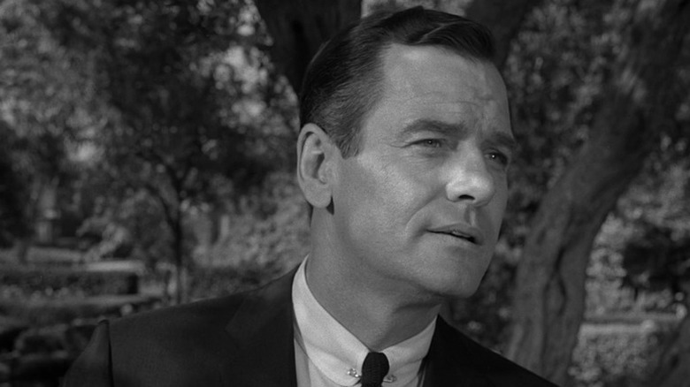 Martin Sloan (Gig Young) walks on a forested road in The Twilight Zone (1959)