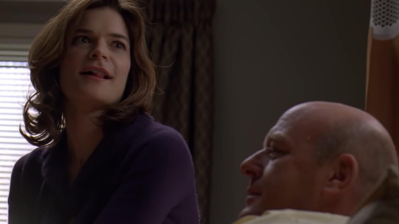 Betsy Brandt as Marie smiling next to Dean Norris as Hank in a hospital bed on Breaking Bad