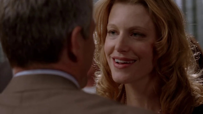 Anna Gunn as Skyler smiling while singing happy birthday on Breaking Bad