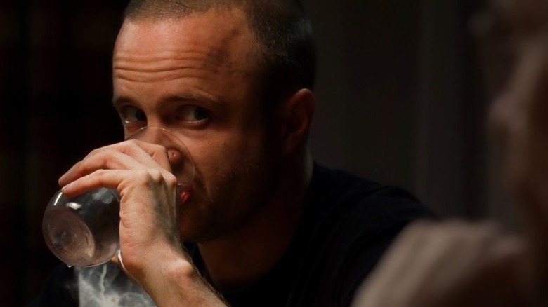 Aaron Paul as Jesse nervously drinking a glass of water on Breaking Bad