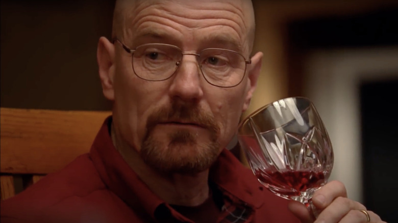 Bryan Cranston as Walter White drinking red wine at dinner on Breaking Bad