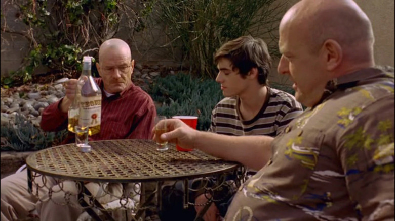 Bryan Cranston as Walter White pouring tequila for RJ Mitte as Walter Jr. and Dean Norris as Hank on Breaking Bad