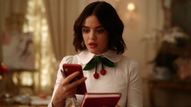 Lucy Hale as Katy Keene looking at her phone in Katy Keene