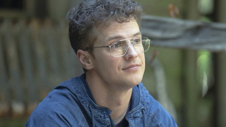 Freddie Stroma's Adrian Chase smiling in Peacemaker