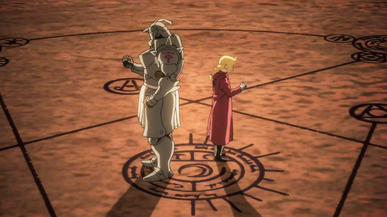 Alphonse and Edward Elric stand back-to-back clutching their fists in Fullmetal Alchemist: Brotherhood