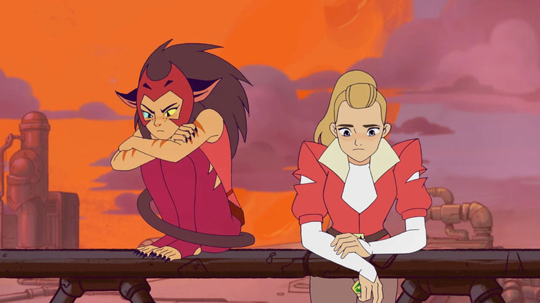 Catra sitting on a railing and Adora leaning over it