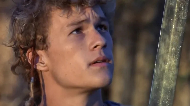 Conor (Heath Ledger) glances at a sword in Roar (1997)