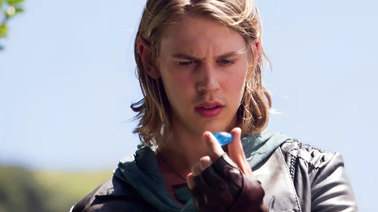 Wil Ohmsford (Austin Butler) examines a blue stone in The Shannara Chronicles
