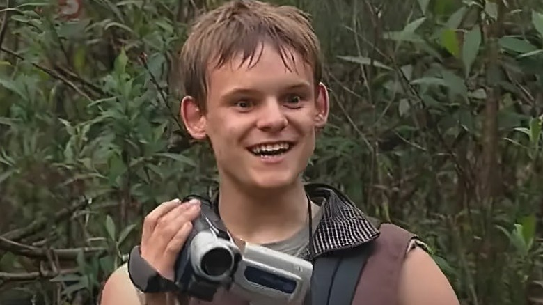 Simon (James Anthony Pearson) holding a camcorder on "Jeopardy."