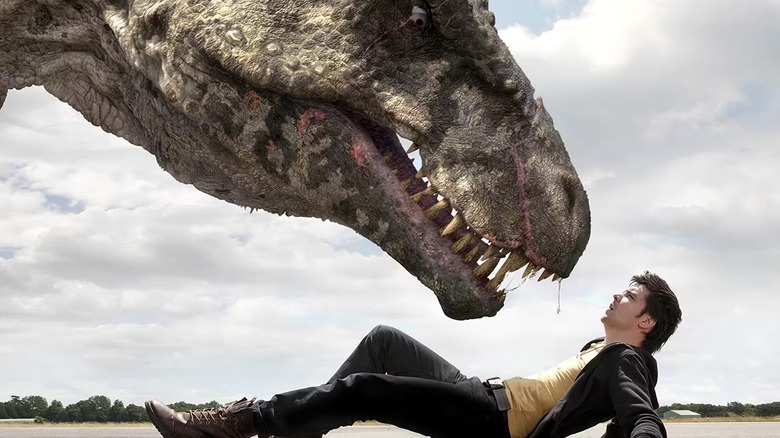 Connor (Andrew-Lee Potts) lying below a dinosaur on "Primeval."