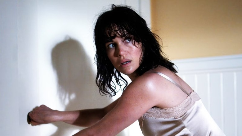 Molly (Carla Gugino) hunched over on "Threshold."