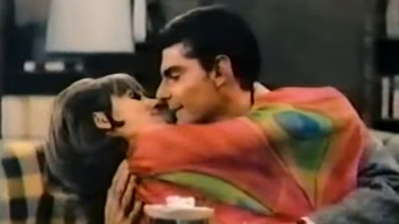 Paula and Dick embracing after a kiss on He & She S1E2