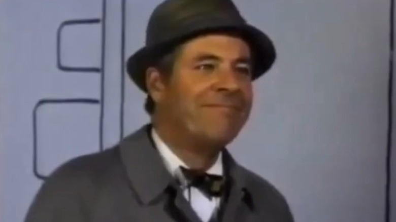 John Monroe smiling in front of a drawn background on My World and Welcome to It S1E14