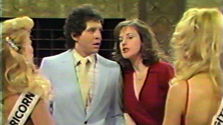 Roger (Steve Guttenberg) and Karen (Hillary B. Smith) look at some beauty pageant contestants in No Soap, Radio