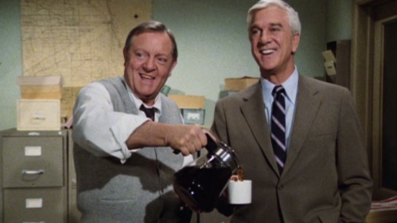 Ed Hocken (Alan North) and Frank Drebin (Leslie Nielsen) freeze frame in Police Squad!