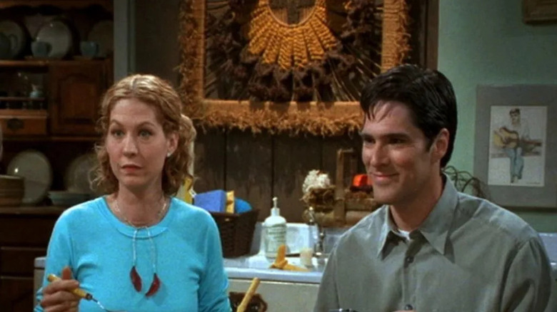 Dharma Finkelstein (Jenna Elfman) and Greg Montgomery (Thomas Gibson) smile in their kitchen in Dharma & Greg