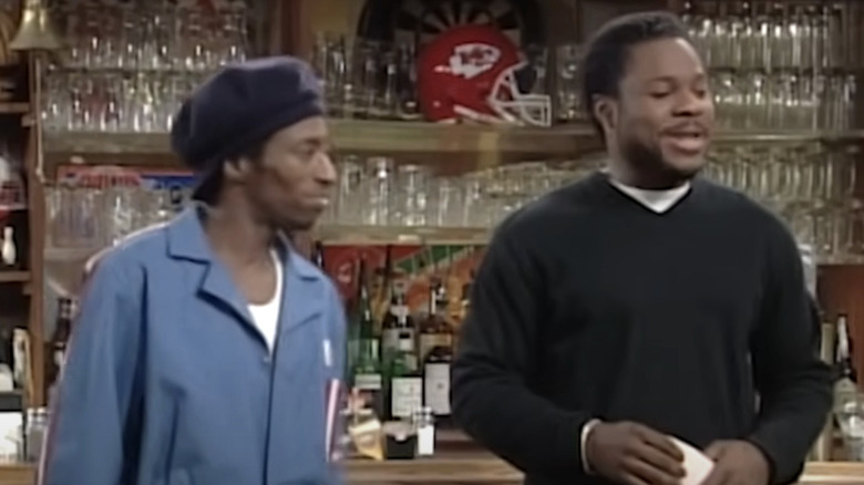 Eddie Sherman (Eddie Griffin) and Malcolm McGee (Malcolm-Jamal Warner) stand behind a bar in Malcolm & Eddie