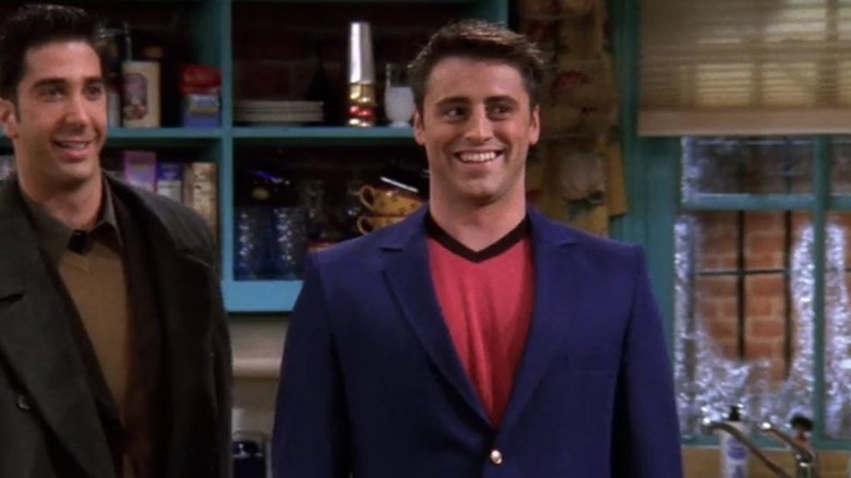 Ross and Joey in a blue blazer standing in Monica's kitchen in Friends