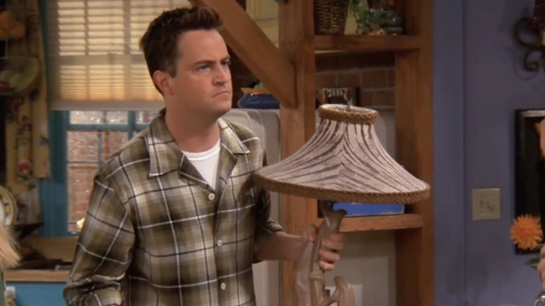 Chandler holding a lamp in Friends