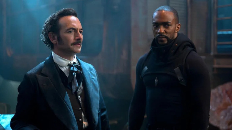 An projection of Edgar Allen Poe (Chris Conner) stands next to Takeshi Kovacs (Anthony Mackie) in Altered Carbon