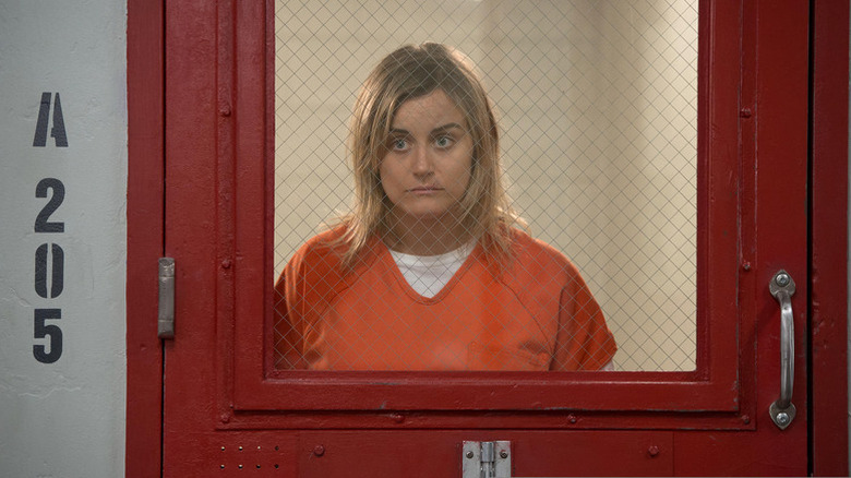 Piper Chapman (Taylor Schilling) stands crestfallen in a cell in Orange Is the New Black