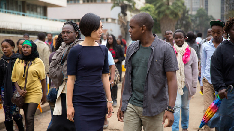 Sun Bak (Bae Doona) and Van Damme (Aml Ameen) look at each other in a crowded street in Sense8