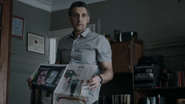 John Stone (John Turturro) holds a newspaper in The Night Of