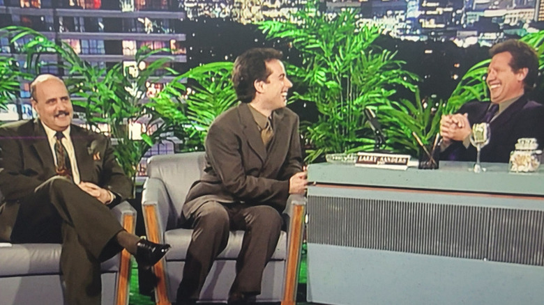 Jeffrey Tambor as Hank Kingsley and Garry Shandling as Larry Sanders, interviewing Jerry Seinfeld in The Larry Sanders Show.