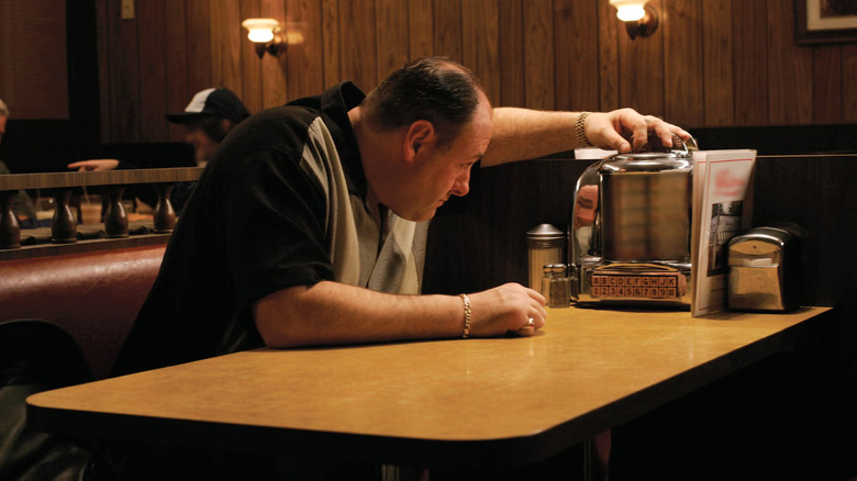 James Gandolfini as Tony Soprano, selecting a song from a jukebox at a diner in The Sopranos.