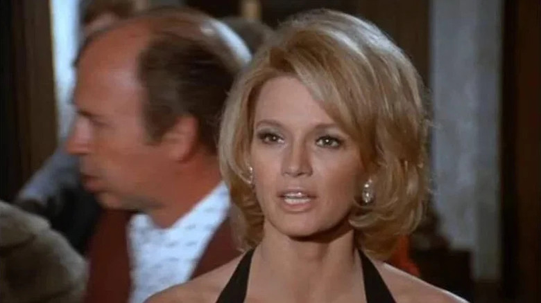 Pepper Anderson (Angie Dickinson) speaks while wearing a black cocktail dress in Police Woman