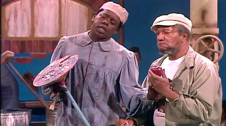 Flip Wilson hands Redd Foxx an apple while dressed as a painter in The Flip Wilson Show