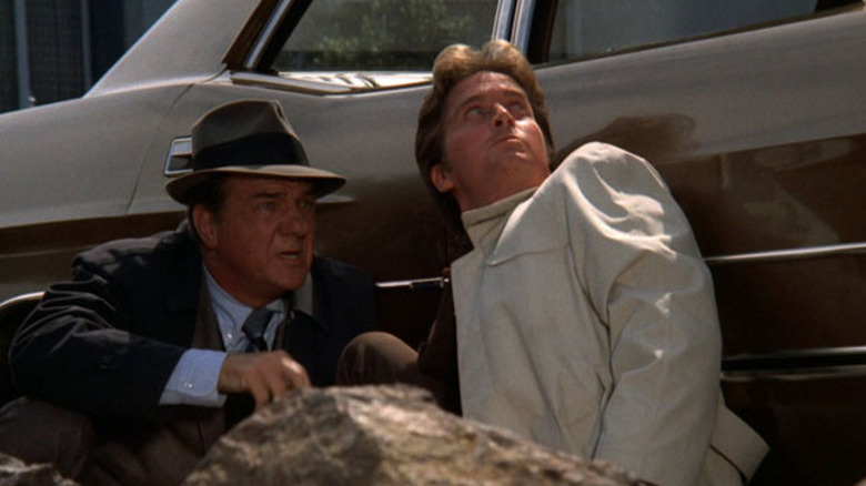 Mike Stone (Karl Malden) and Steve Keller (Michael Douglas) take cover behind a car in The Streets of San Francisco