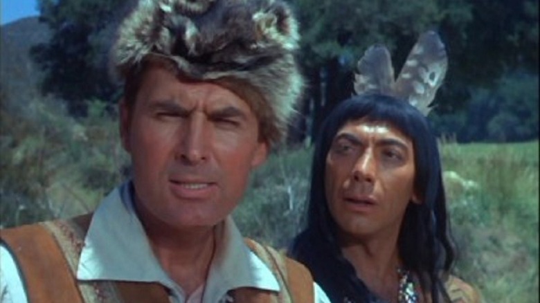Daniel Boone (Fess Parker) peers ahead as Mingo (Ed Ames) glances at him in Daniel Boone