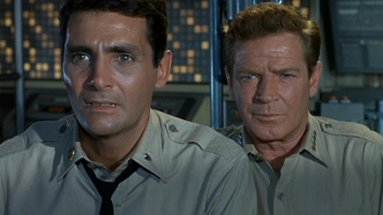 Admiral Harry Nelson (Richard Basehart) and Commander Lee Crane (David Hedison) stare nervously in a control room in Voyage to the Bottom of the Sea