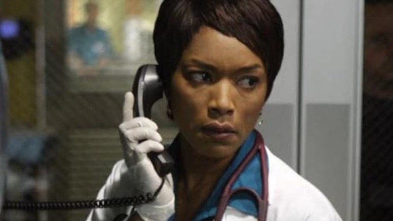 Cate Banfield talks on the phone in ER