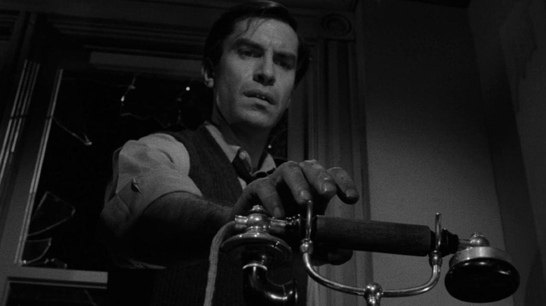 Ivan Kuchenko (Martin Landau) reaches for phone in The Twilight Zone