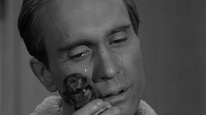 Charley Parkes (Robert Duvall) holds a doll in The Twilight Zone