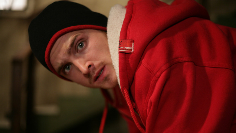 Aaron Paul as Jesse Pinkman leans over on Breaking Bad
