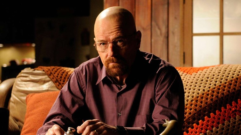 Bryan Cranston as Walter White sits on a couch on Breaking Bad