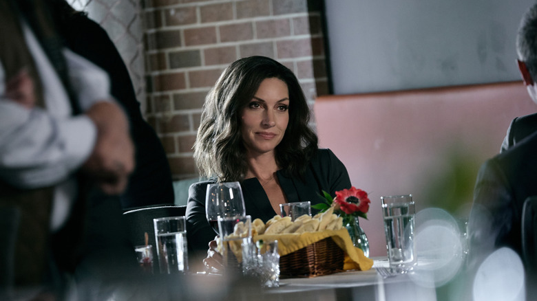 Dawn Olivieri's Sarah Atwood sitting at a restaurant table on Yellowstone